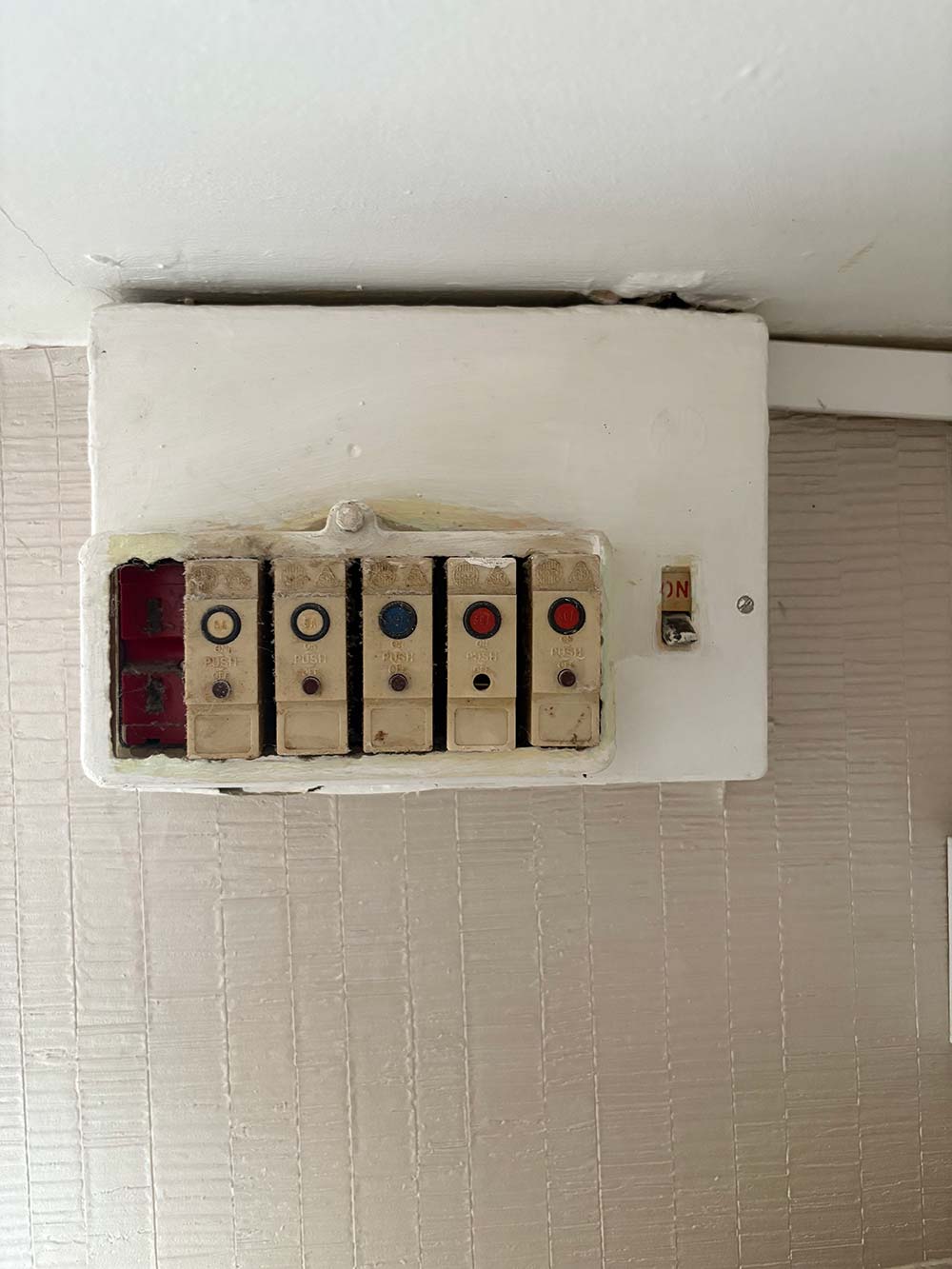 Old fuse box before upgrade by an electrician in Melton Mowbray